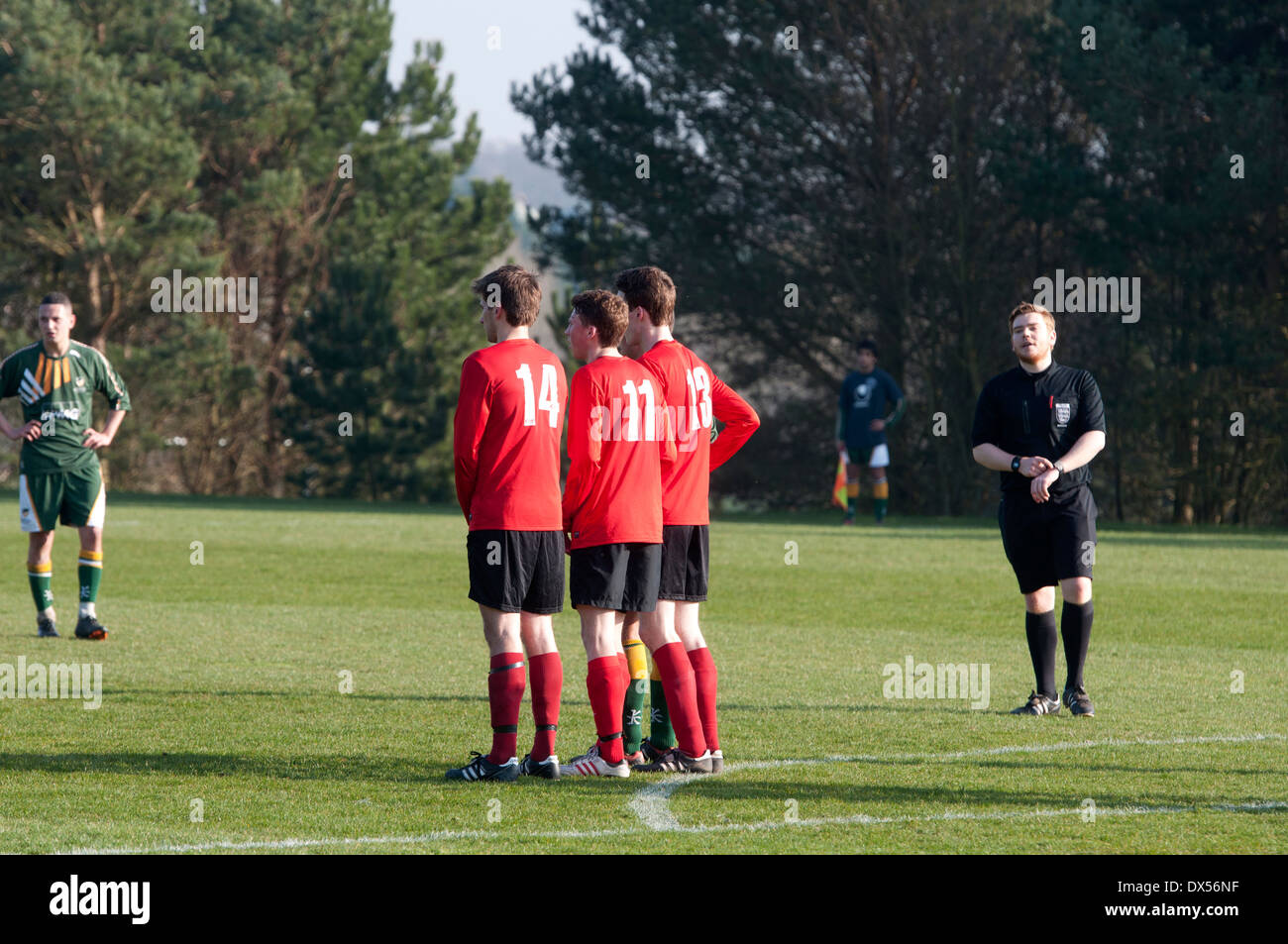 University sport. Men`s football. Players forming a wall for a free